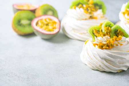 Homemade cake Pavlova with whipped cream, fresh kiwi and passion fruit.の写真素材