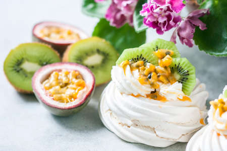 Homemade cake Pavlova with whipped cream, fresh kiwi and passion fruit. Selective focusの写真素材