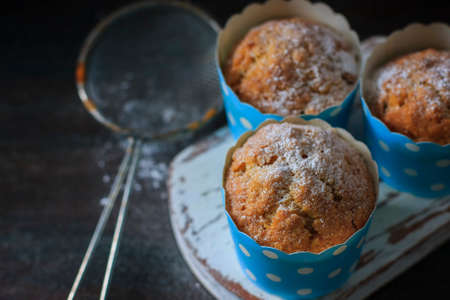 Muffins, cakes with almond nuts on a dark background. Copy space. Selective focusの写真素材