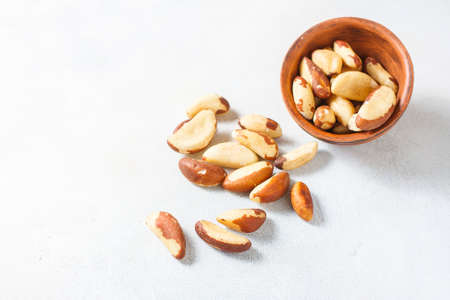 Wooden bowl with Brazil nuts on a light background. Healthy food. Selective focusの写真素材