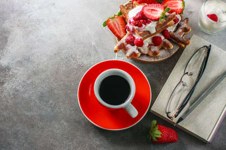 Belgian waffles with creem, raspberries, strawberriesand coffee , top view with copy space. Selective focusの写真素材