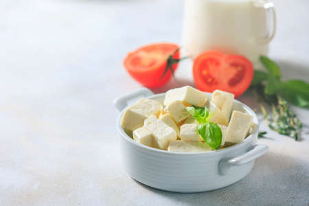 Homemade cheese with herbs on a light background. Copy space background. Selective focusの写真素材