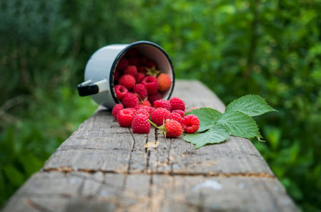 Ripe raspberries on a wooden table. Selective focus