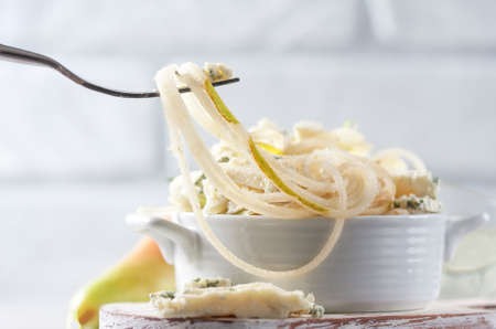 The concept of a healthy diet and diet. Fresh raw macaroni from pear with blue cheese.の写真素材