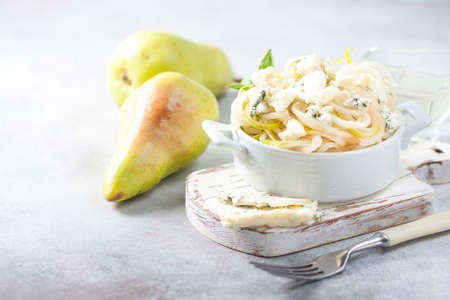 The concept of a healthy diet and diet. Fresh raw macaroni from pear with blue cheese.の写真素材