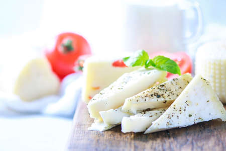 Homemade cheese halloumi with herbs on a light background. Copy space background.の写真素材