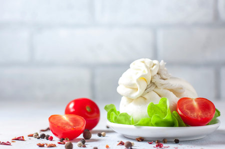 Italian Cream Burrata Cheese on light background.