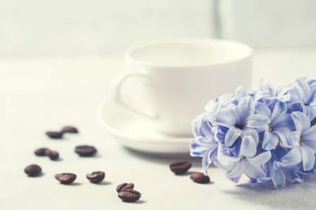 White coffee cup on a white background and flowers. Selective focusの写真素材