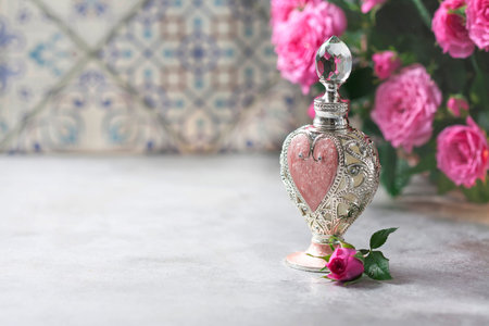 Natural pure rose oil or scented water in bottles for spa, skin care or aromatherapy. Glass bottle...