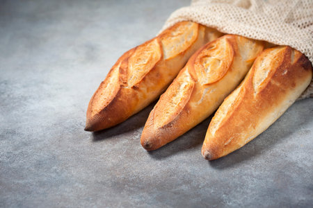Fresh homemade crispy baguette in an eco bag. eco style no plastic. Copy space.