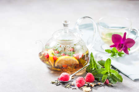 Hot herbal tea with lemon, raspberries and mint. Healthy lemon tea.の写真素材
