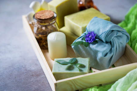 Organic cosmetics. Eco handmade soap, spa products in a wooden box. No plastic, green life and zero waste concept. Japanese Furoshiki style. opy spaceの写真素材