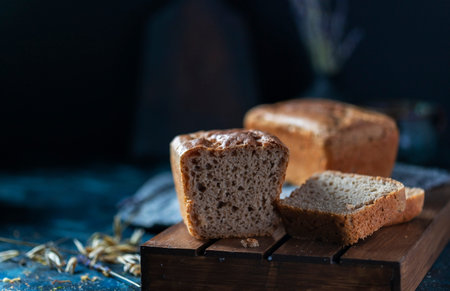 Sourdough bread. Sliced rye bread on a dark background. Healthy eating concept. Selective focus,...