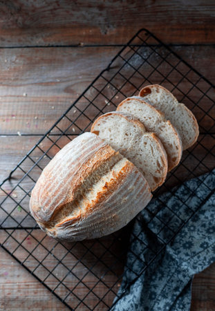 Homemade loaf of freshly backed sourdough bread. Selective focus, copy spacy. Flat lay