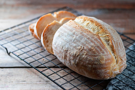 Homemade loaf of freshly backed sourdough bread. Selective focus, copy spacy.