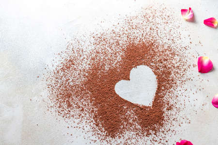 Heart made of cocoa powder on white background. The idea for a festive breakfast, Valentines Day.の写真素材