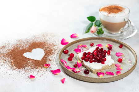 Heart shaped cappuccino and cheese sandwich with red berries.The idea for a festive breakfast,...