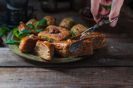 Ramadan kareem with arabic coffee and traditional arabic dessert baklava with honey and nuts. Arabian style. Ramadan breakfast concept.の写真素材