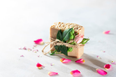 Organic handmade soap, pink rose bud on a white concrete background. Natural and non-waste cosmetic...