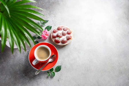 A cup of espresso coffee, a cake with raspberries. Good morning concept. Selective focus, top view.の写真素材