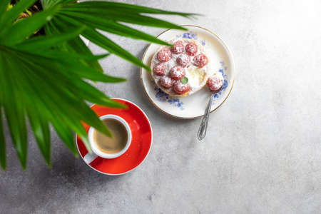 A cup of espresso coffee, a cake with raspberries. Good morning concept. Selective focus, top view.の写真素材