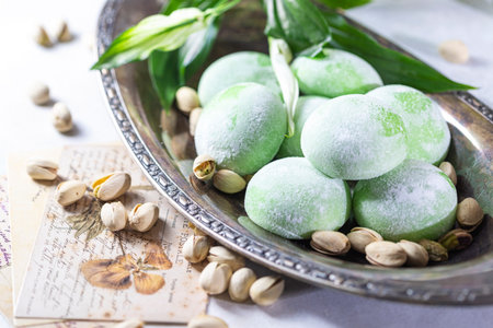 Japanese ice cream Mochi with pistachios in rice dough. Traditional Japanese dessert on white...