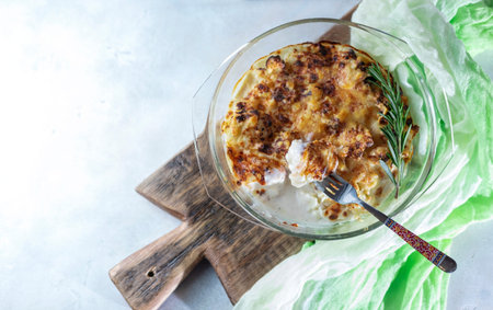 casserole from cauliflower with bechamel sauce in a glass baking dish. Selective focus, copy space