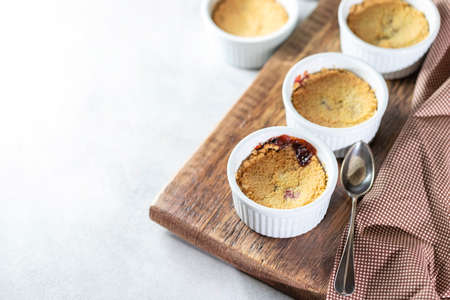 Crumble with cherry on a light background. Selective focus, copy space. Top view.の写真素材