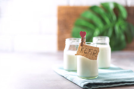 Fermented drink kefir in a glass jar on a light background. Probiotic cold fermented dairy drink. Copy spaceの写真素材