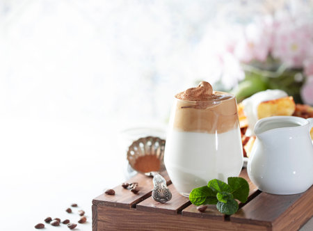Iced frothy drink Dalgona Coffee, trend korean drink latte espresso with coffee. Gray concrete background. Selective focus, copy spaceの写真素材
