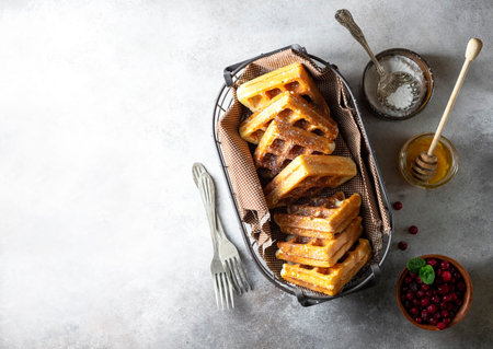 Gluten-free homemade waffles on a light gray concrete background. Selective focus, copy space.