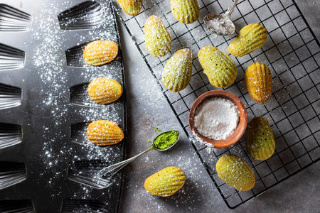 Madeleine homemade cookies with matcha tea. Selective focus, copy space.