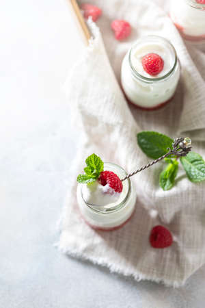 Fermented drink kefir, yogurt in a glass jar on a light background. Probiotic cold fermented dairy drink. Copy space. Flat layの写真素材