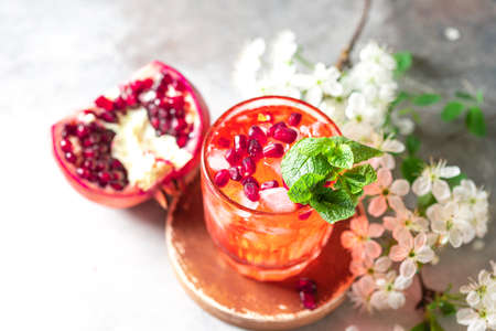 Fresh cold pomegranate lemonade. Homemade lemonade with ice. Selective focus, copy space.の写真素材
