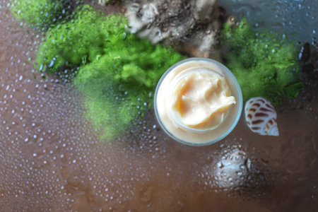 Cosmetic cream on background with a water pool. Cealthcare and medicine concept. Top view