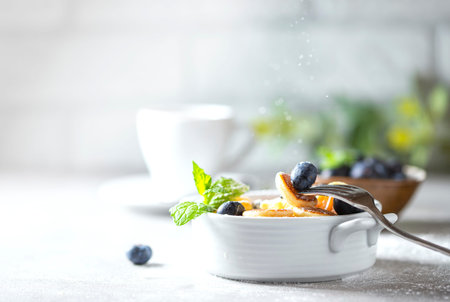 Bowl with tiny pancake cereal on a light concrete background. Trendy food. Mini cereal pancakes with...