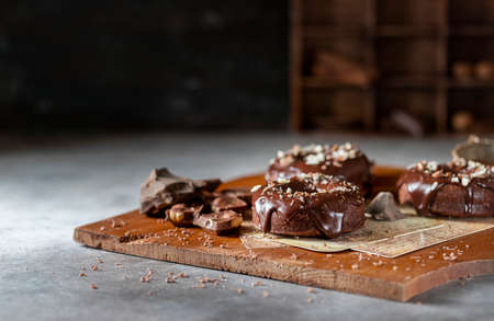 Chocolate donuts with chocolate glaze, nuts. National Donut Day. Homemade baking. Selective focus, copy spaceの写真素材