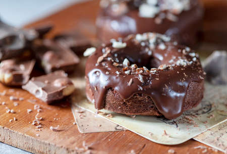 Chocolate donuts with chocolate glaze, nuts. National Donut Day. Homemade baking. Selective focus, copy spaceの写真素材