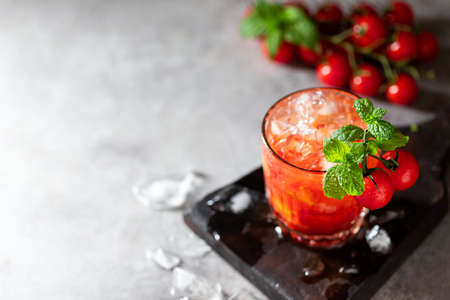 Ice tomato juice in a glass goblet. Selective focus.の写真素材