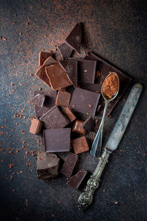 Dark and milk chocolate on a concrete background. Selective focus, top view.の写真素材