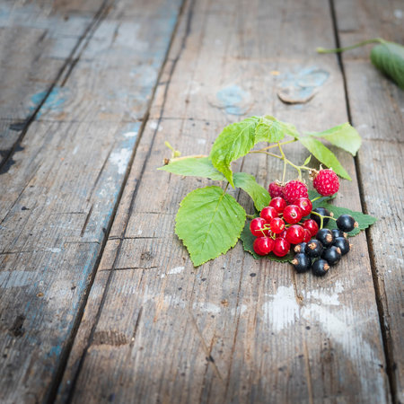 Ripe and juicy berries on an old wooden background.
