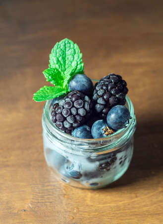 Frozen blackberry and blueberry berries, closeup. Selective focus, copy space.の写真素材