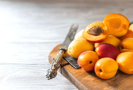 Ripe fresh apricots on a wooden background. Summer fruit concept. Rustic style. Free space for your text, selective focusの写真素材