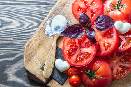 Chopped tomato. Red tomatoes on a wooden cutting board. Selective focus. Copy spaceの写真素材