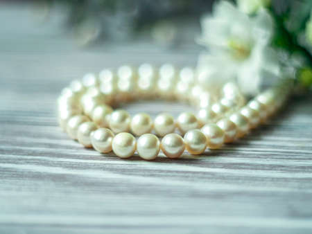 White pearl necklace with white flowers, macro. Selective focusの写真素材