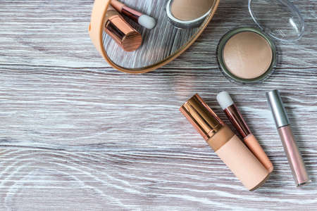 Decorative cosmetic make up tools and coffee cup. Breakfast and make up set. Concept of female mockup. Flat lay and copy spaceの写真素材