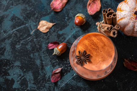 Spicy cocktail, pumpkin smoothie with cinnamon, anise. Traditional autumn food.