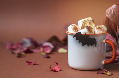 Cup of hot chocolate with marshmallow. Tasty Halloween food. Concept of cozy winter home...