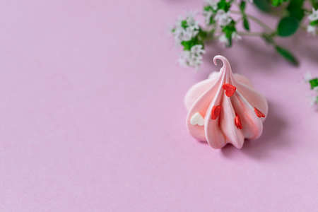 Close-up small pink meringues on a pink background. Handmade. Celebration. Selective focus, copy spaceの写真素材