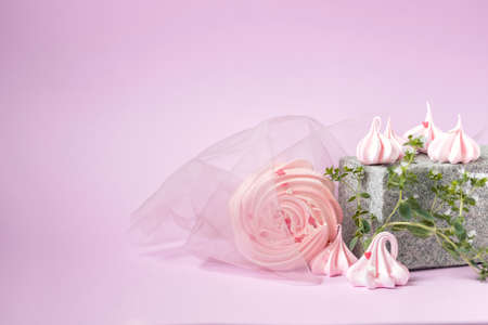 Pink meringues close-up on a creative stone podium on a pink background. Handmade meringue. Contemporary still life. Selective focus, copy spaceの写真素材
